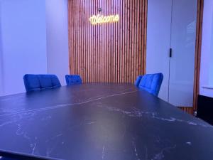 a conference room with a large table and blue chairs at Luxury Hot Tub Retreat Derry City in Derry Londonderry