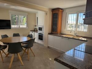a kitchen with a table and chairs in a kitchen at Casa Estrella Gandia in Gandía