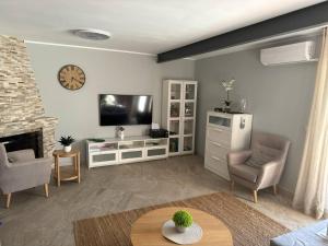 a living room with a tv and a fireplace at Casa Estrella Gandia in Gandía