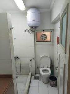 a small bathroom with a toilet in a stall at LH HOUSE in Amman