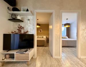 a living room with a television and a bedroom at Apartments Sinisa - Krk Town in Krk