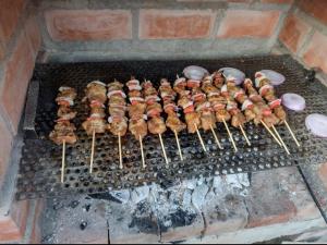 a bunch of food cooking on a grill at Casita de Playa in Barranca