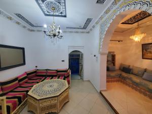 a living room with a table and a couch at Blue City in Chefchaouen