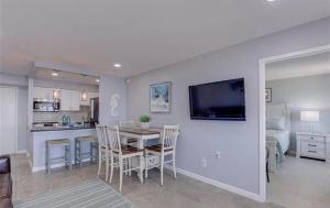a dining room and kitchen with a table and chairs at Oceanfront Condo with Pool and Hot Tub! in Virginia Beach