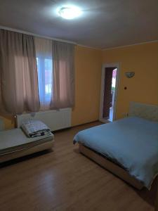 1 dormitorio con 2 camas y ventana en Pariska Noć, en Loznica