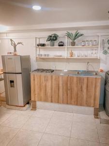 a kitchen with a sink and a refrigerator at Madrigal Luxury Loft M01 in Florencia