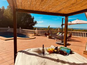 una mesa con un plato de comida y una botella de vino en Denia Dream Seaview Golf, Tennis & Beach Villa, en Muntanya la Sella