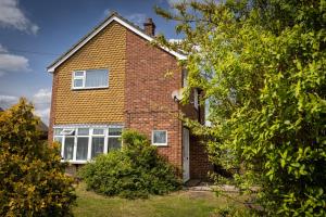 a brick house with a window on the side of it at Epiphany homes - 4 bedroom house in Norwich - Contractor friendly - close to airport and hospital in Norwich