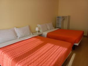 two beds sitting next to each other in a room at Barra Atlântica Apartment 2 in Praia da Barra