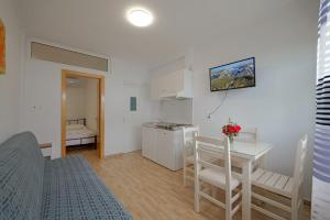 un salon avec une cuisine et une table ainsi qu'une chambre dans l'établissement Eduard Lagji Apartament, à Lukovë