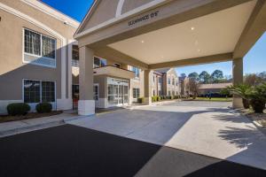 a rendering of the entrance to a building at Red Roof Inn & Suites Albany, GA in Albany