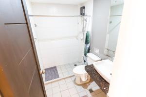 a bathroom with a toilet and a sink at Spotlight Hotel in Alaminos