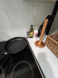a black frying pan sitting on top of a stove at CityStation 59m2 Top Floor Sauna Apartment, WiFi in Lahti +8 photos