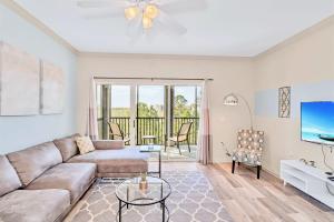 a living room with a couch and a tv at Spacious 3BR Near Disney - Pool and Hot Tub! in Orlando