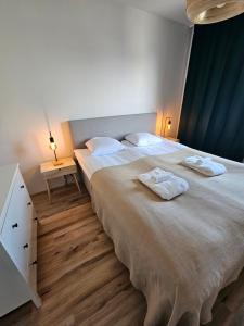 a bedroom with two beds with towels on them at CityStation 59m2 Top Floor Sauna Apartment, WiFi in Lahti