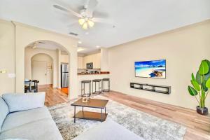 a living room with a couch and a table at Bright Condo - 2BR with Pool & Hot Tub, near Disney! in Orlando