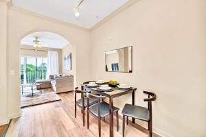 a dining room and living room with a table and chairs at Bright Condo - 2BR with Pool & Hot Tub, near Disney! in Orlando