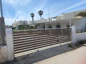 a fence in front of a building with palm trees at Private 24sqm Studio in Lambi, Kos in Kos