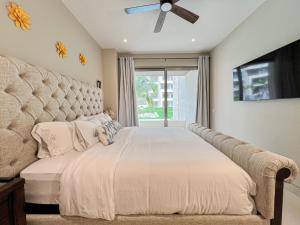 a bedroom with a large bed with a large headboard at New Condo! Vista Velas III in El Pueblito