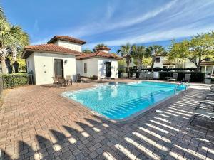 a swimming pool in front of a house at 1953 Villa Lago in Destin