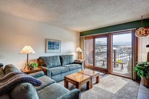 a living room with a couch and a table at Sawmill Creek Condo 207 by Great Western Lodging in Breckenridge