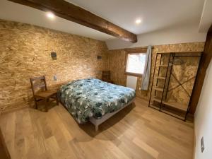 a bedroom with a bed and a stone wall at Grange rénovée, 6 minutes du Lac d'Annecy vue sur le Mont-Blanc in Giez +28 photos