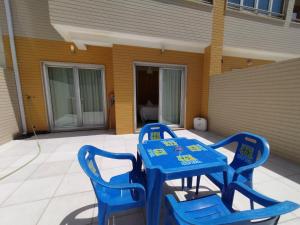 una mesa azul y sillas en un patio en Barra Atlântica Apartment 2, en Praia da Barra