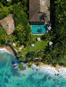 an aerial view of a resort with a swimming pool and the ocean at Eraeliya Villas & Gardens in Weligama