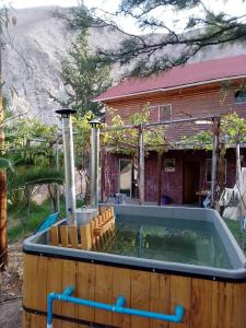a large pool of water in front of a house at Hermosa casa familiar para 8 personas con tinaja-Cochiguaz Valle de Elqui in Paihuano