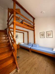 a living room with a bunk bed and stairs at Rustic Villa in Jagodina