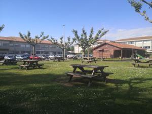 a group of picnic tables in a park at O RECUNCHO DE MORA in Ribeira