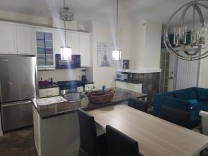 a kitchen with a table and a counter top at Modern Townhouse in Vancouvers Vibrant Heart in Vancouver