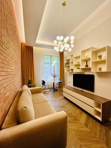 a living room with a couch and a television at PoshSpot Apartments in Cluj-Napoca