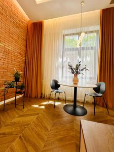 a dining room with a table and chairs and a window at PoshSpot Apartments in Cluj-Napoca