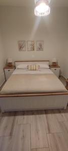 a bedroom with a bed and a chandelier at Casa di Calma in Ermoupoli