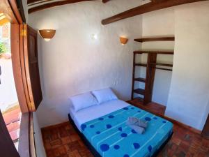Postel nebo postele na pokoji v ubytování La Casa Del Toche Barichara