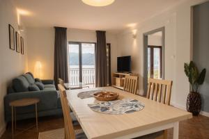 a kitchen and living room with a table and a couch at Apartments Djurovic in Kotor