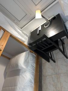 a loft bed with a desk in a room at Scalo 71 GUEST HOUSE in Rome