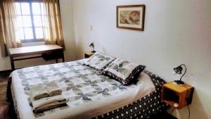 a bedroom with a bed and a table and a window at G Duplex estratégico en ciudad de Mendoza in Mendoza