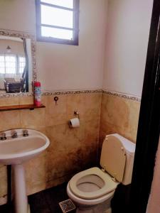 a bathroom with a toilet and a sink at G Duplex estratégico en ciudad de Mendoza in Mendoza