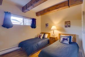 two beds in a room with a window at Ten Mile Creek 115 by Great Western Lodging in Frisco