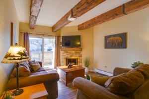 a living room with two couches and a fireplace at Ten Mile Creek 115 by Great Western Lodging in Frisco