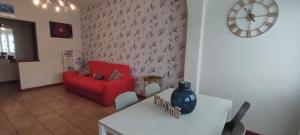 a living room with a red couch and a table at Casa da Mary in Iseo