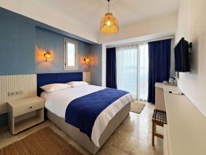 a bedroom with a bed and a blue wall at Nese Pension in Bodrum City