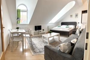 a living room with a couch and a bed at Vienna Excellent Apartments in Vienna