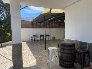 a group of stools and a barrel on a patio at Granada Sights in Las Gabias