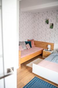 a living room with two beds and a couch at Pensjonat Kaja in Rymanów-Zdrój