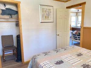a bedroom with a bed and a chair in a room at Blue Horizon Lodge in Big Bear Lake