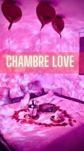 a bed with red hearts and a sign that says champagne love at Magnifique Appartement Cosy in Neuilly-Plaisance