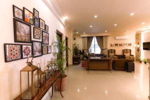 a living room filled with lots of pictures on the wall at Shelton Rezidor House Peshawar in Peshawar